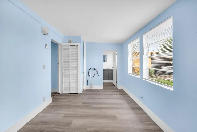 a view of a livingroom with wooden floor and a window