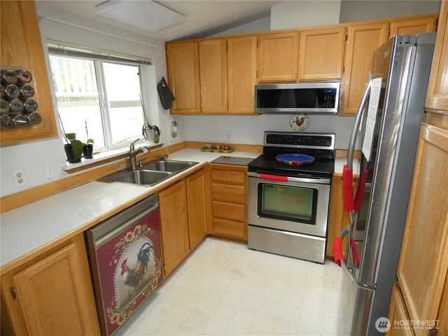 a kitchen with a sink stove and microwave