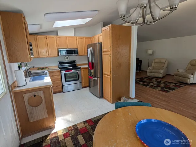 a kitchen with stainless steel appliances a stove a refrigerator and a refrigerator