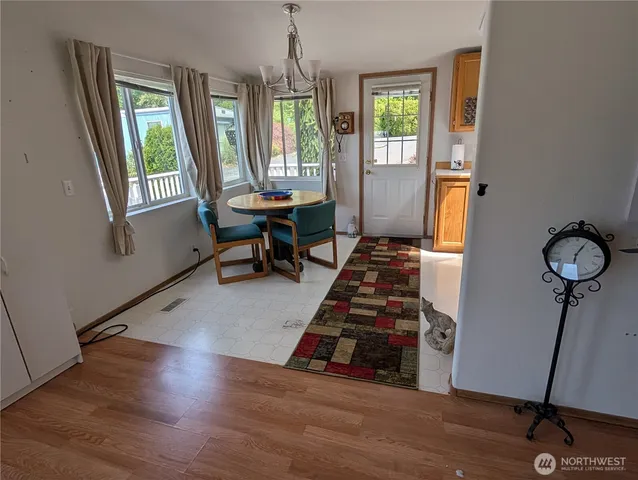 a view of a room with wooden floor and windows