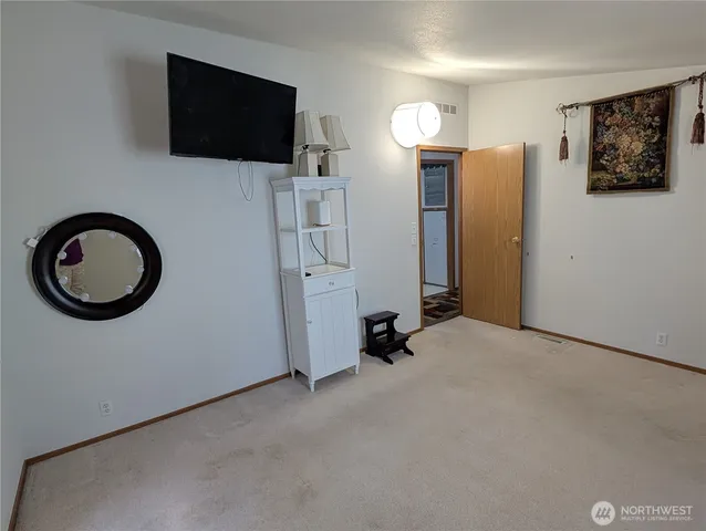 a view of a livingroom with furniture and a flat screen tv