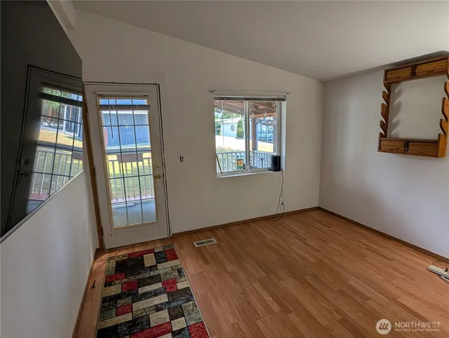 a view of wooden floor and windows in a room
