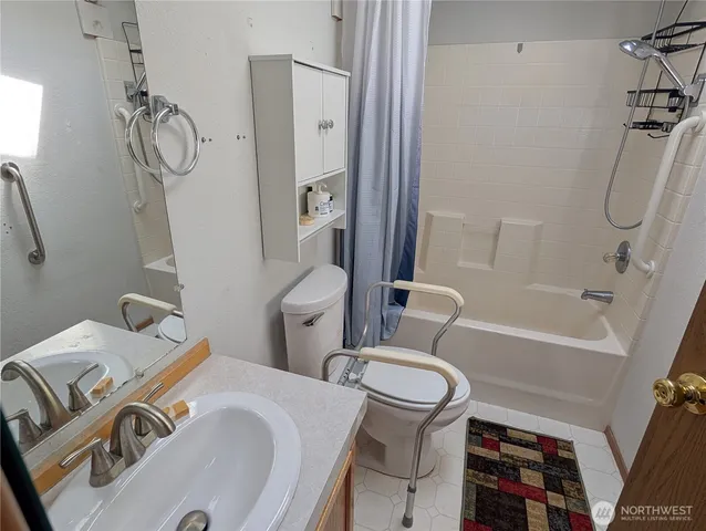 a bathroom with a toilet sink and shower