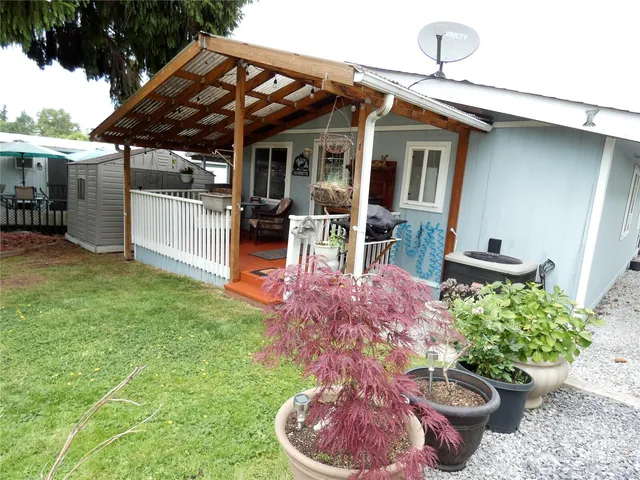 a view of a backyard with plants and patio