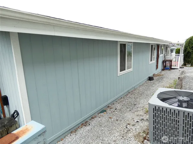 a view of a sink and dishwasher with wooden floor