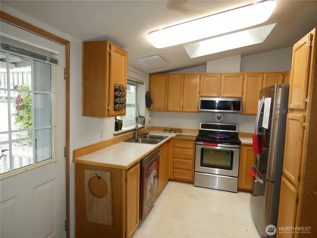 a kitchen with a sink stove and refrigerator