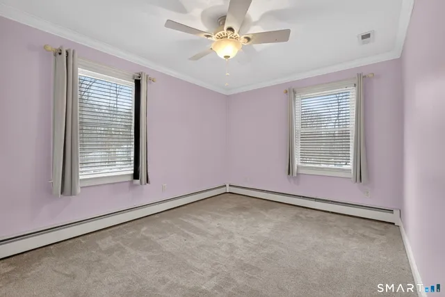 an empty room with closet and a chandelier fan