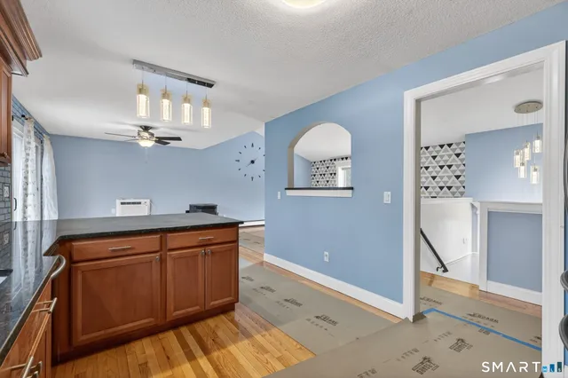 a view of a kitchen with cabinets and wooden floor