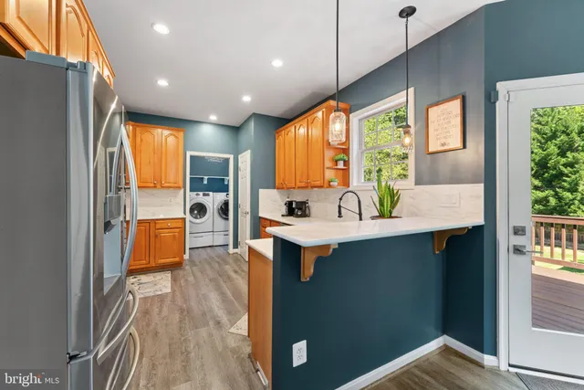 a kitchen with stainless steel appliances granite countertop wooden cabinets a sink and a stove