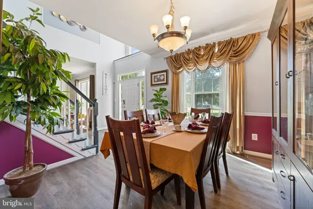 a view of a dining room with furniture wooden floor and chandelier