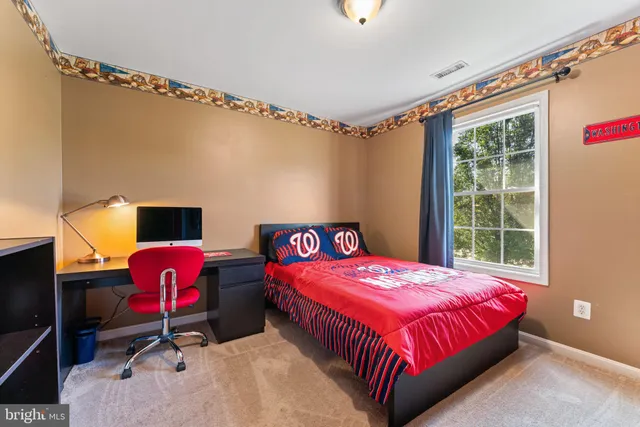 a bedroom with a bed and a dresser