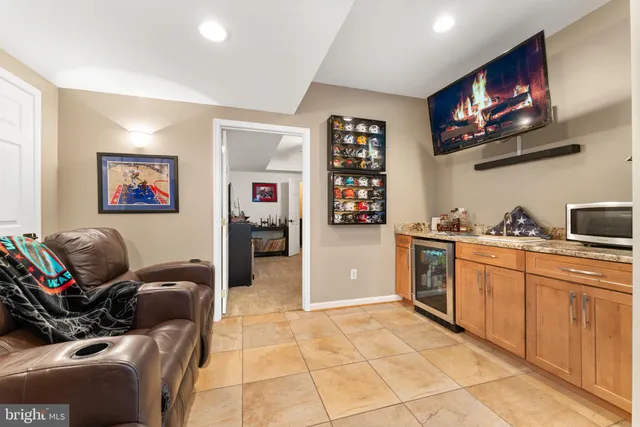 a view of a white house with a big yard plants and large trees