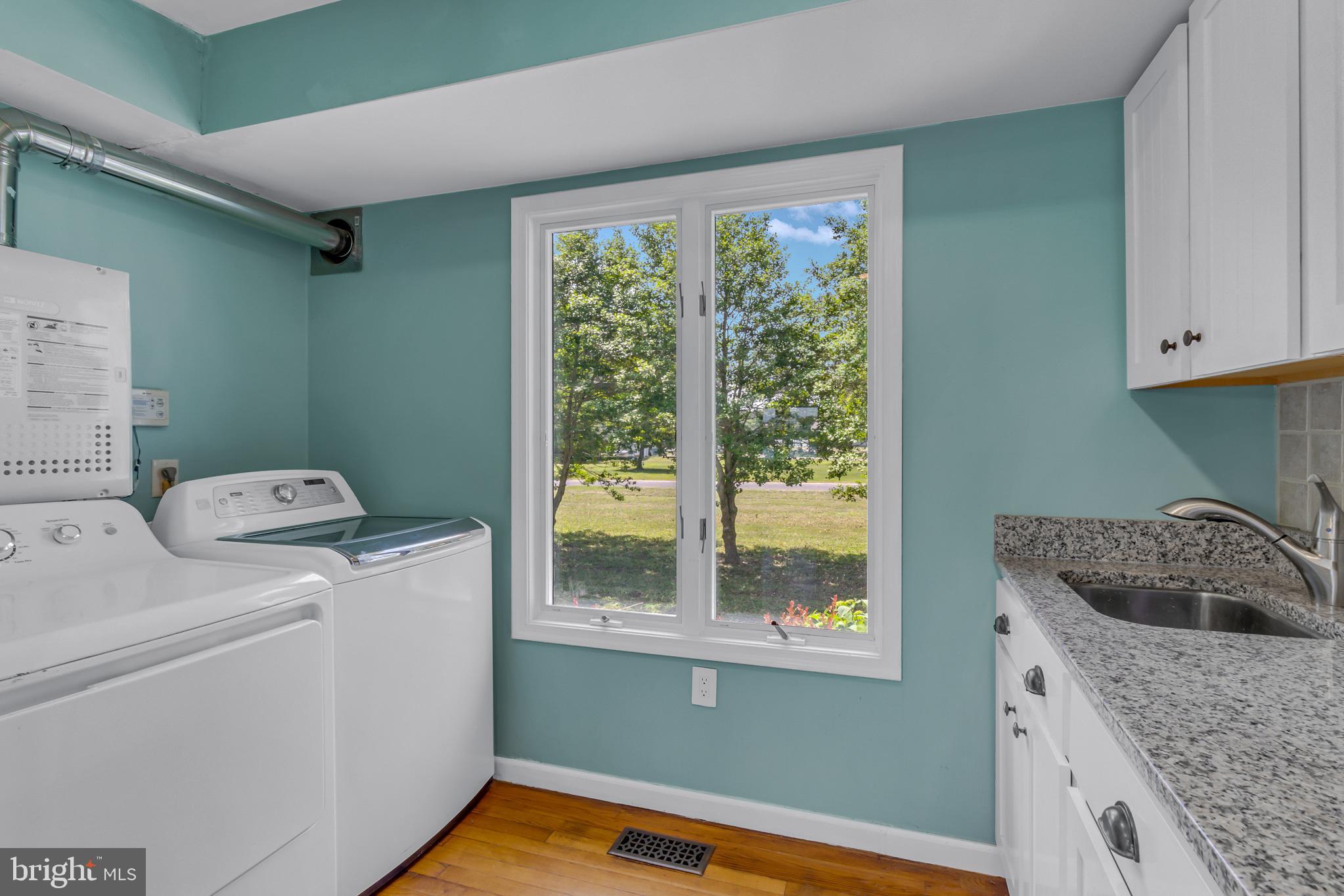 2215 Ditchley Road Kilmarnock, VA 22482 - Photo 85 of 103 Laundry room with granite countertop and cabinets