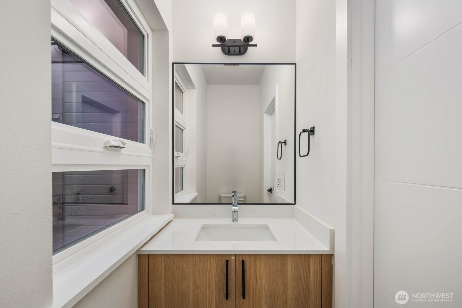 548 South Cloverdale Street, Unit D Seattle, WA 98108 - Photo 21 of 40 a bathroom with a sink and a mirror