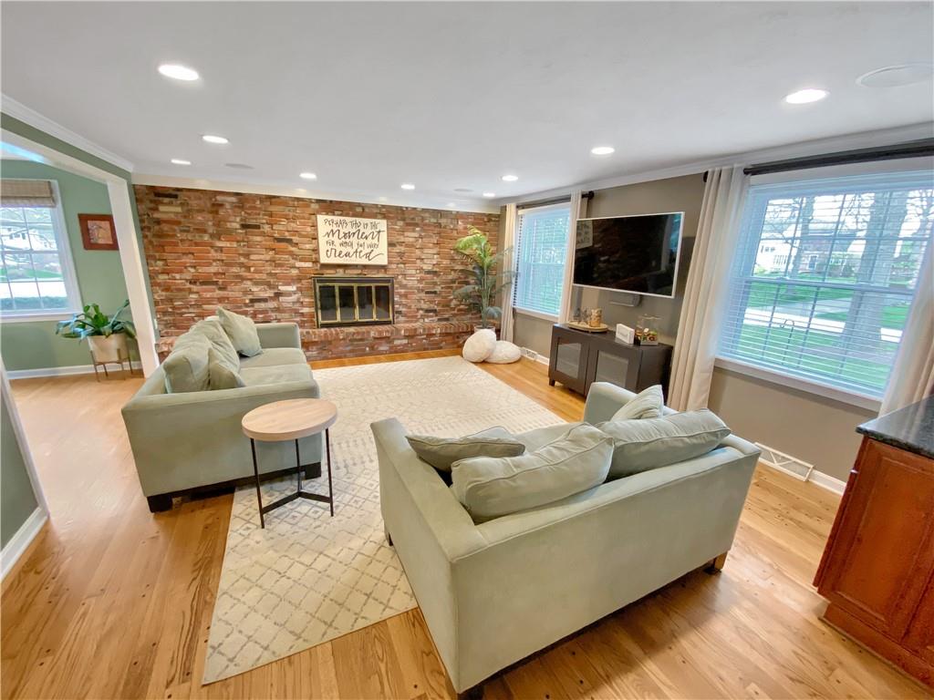 108 Lamar Road Pittsburgh, PA 15241 - Photo 14 of 40 A first floor family room features pegged wood floors, recessed lighting, and a brick fireplace.