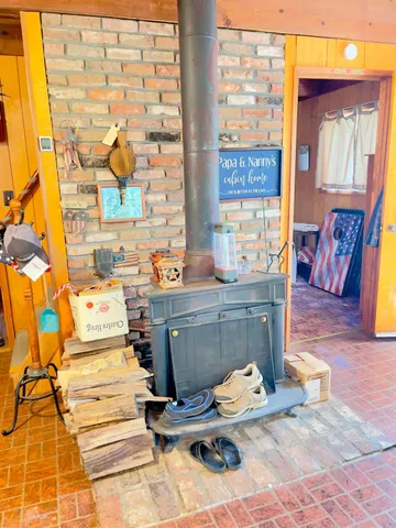 a kitchen with kitchen island granite countertop a stove a sink and white cabinets