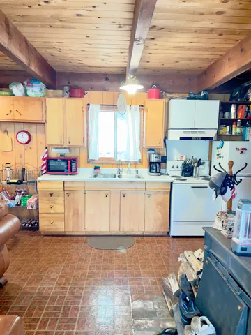a kitchen with stainless steel appliances granite countertop a sink and a refrigerator