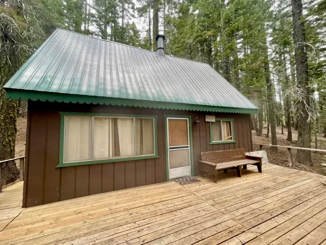 a backyard of a house with wooden floor and fence