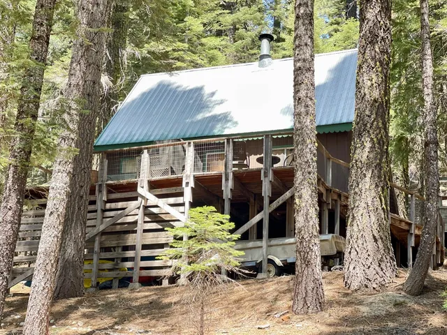a view of a house with a yard and sitting area