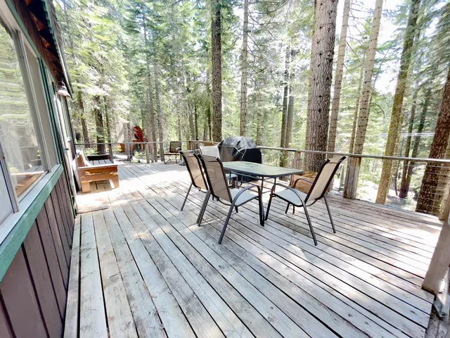 a view of a patio with lawn chairs floor to ceiling window with wooden floor