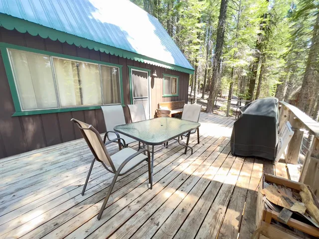 a roof deck with couches and wooden floor
