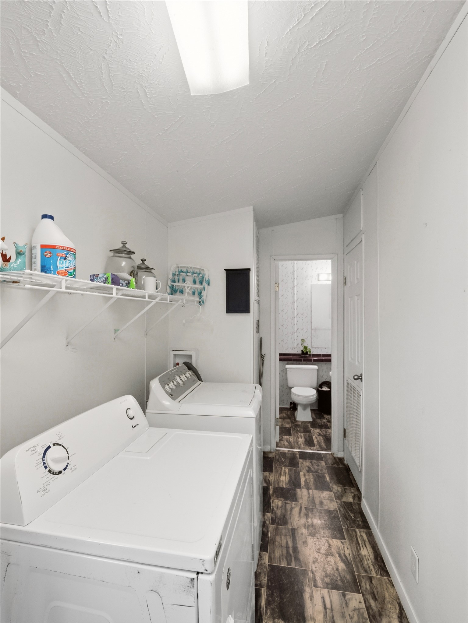 13241 2338th Road Georgetown, TX 78633 - Photo 20 of 26 Functional laundry room offering a dedicated space for household chores, leading to a half-bathroom.