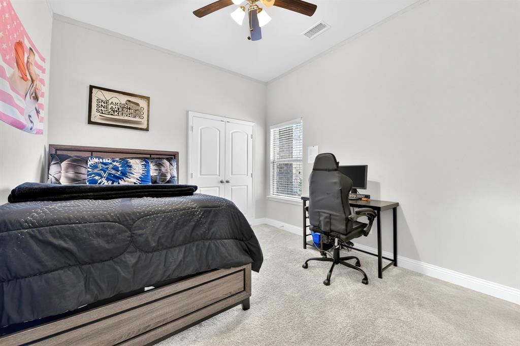 136 Gleeson Drive Red Oak, TX 75154 - Photo 29 of 40 a bedroom with furniture and a bed