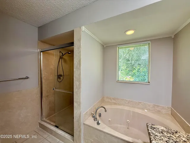 a bathroom with a bathtub and a shower