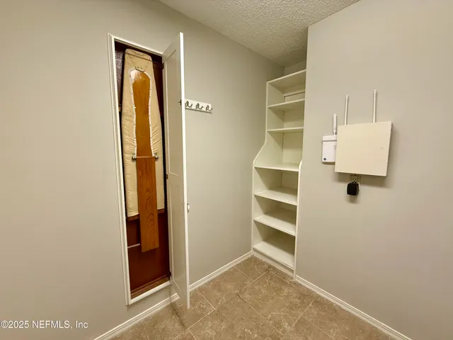 a view of walk in closet with empty racks