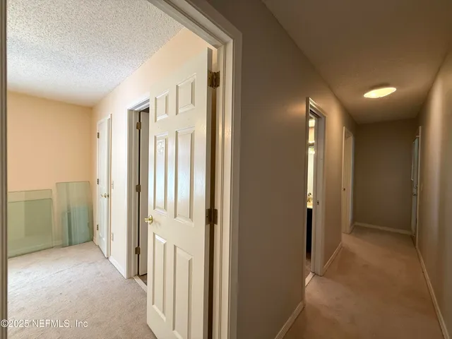 a view of a hallway with wooden shelves