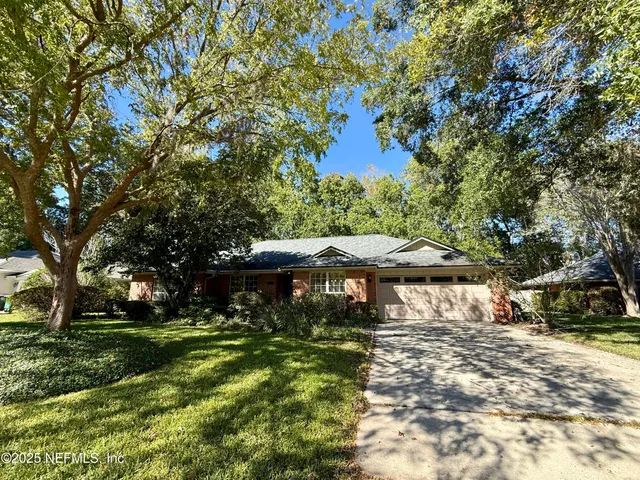 a view of house with a yard