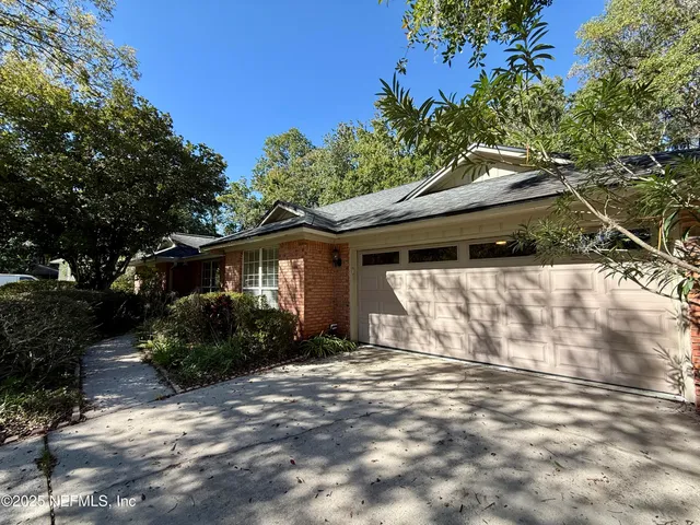 a backyard of a house with plants and trees