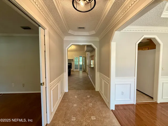 a view of hallway with wooden floor