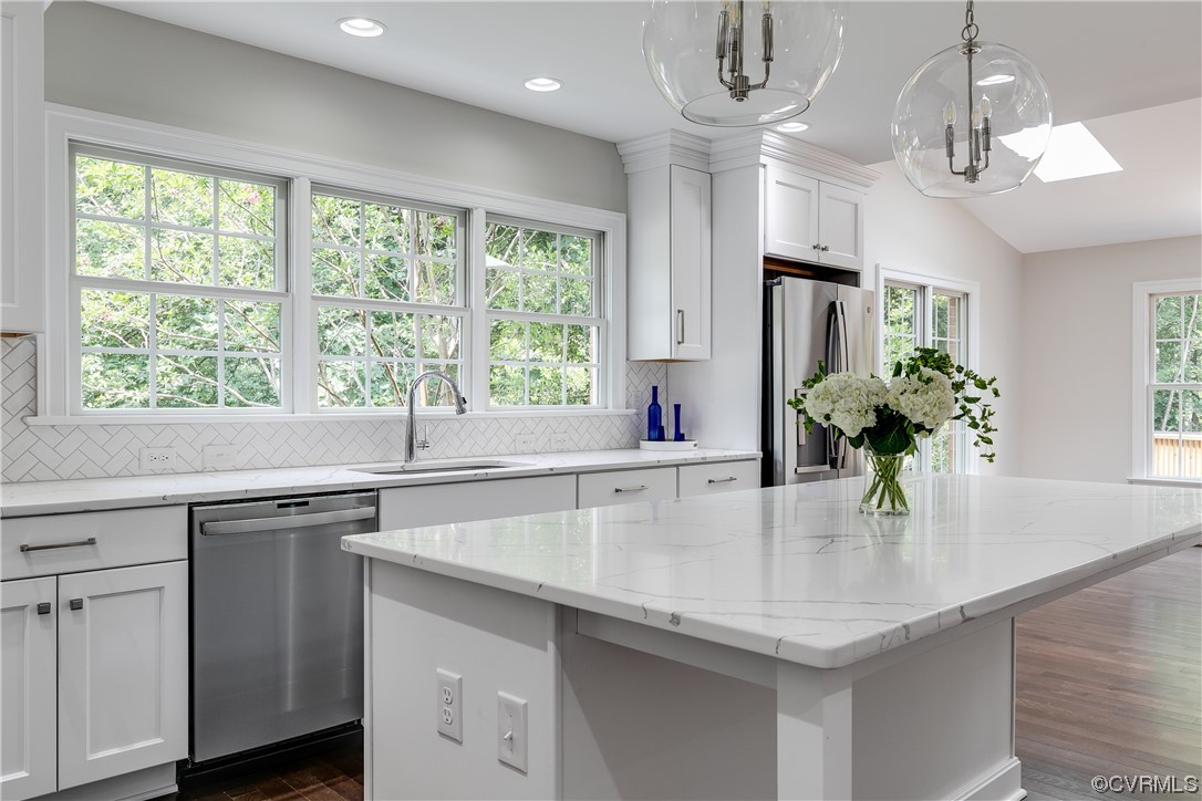 14221 West Salisbury Road Midlothian, VA 23113 - Photo 12 of 43 a kitchen with stainless steel appliances a sink a large window and wooden floor