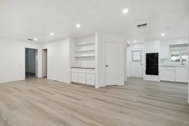 a kitchen with granite countertop a sink stove and cabinets