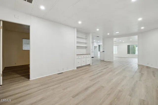 a kitchen with stainless steel appliances a white stove top oven and a refrigerator