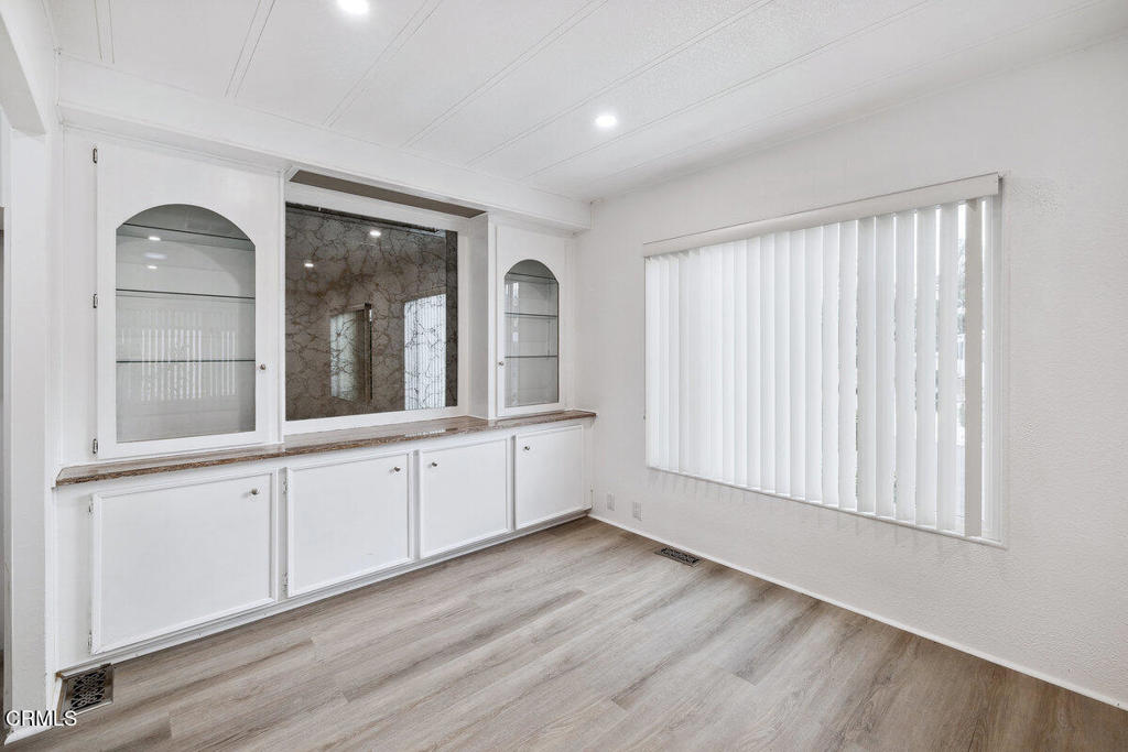 206 Browning Avenue, Unit 206 Ventura, CA 93003 - Photo 22 of 36 a view of an empty room with window and wooden floor