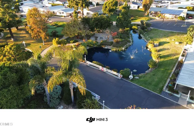 an aerial view of a house with a yard and lake view