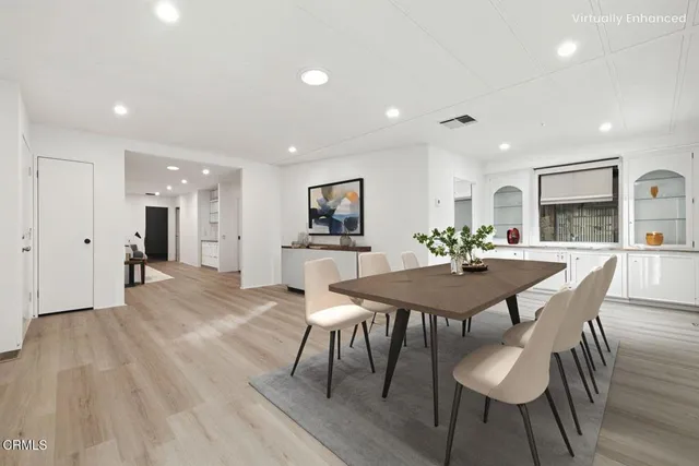 a view of empty room with wooden floor and windows