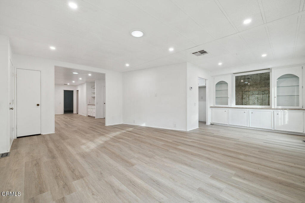 206 Browning Avenue, Unit 206 Ventura, CA 93003 - Photo 10 of 36 a view of empty room with wooden floor and windows