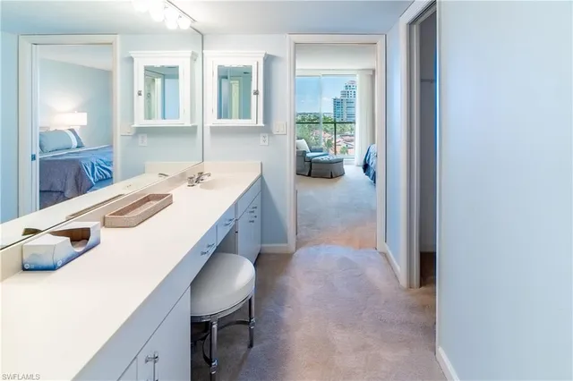 a spacious bedroom with a bed and large windows