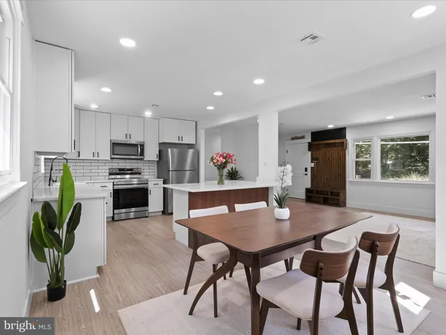 a view of a dining room with furniture and a potted plant