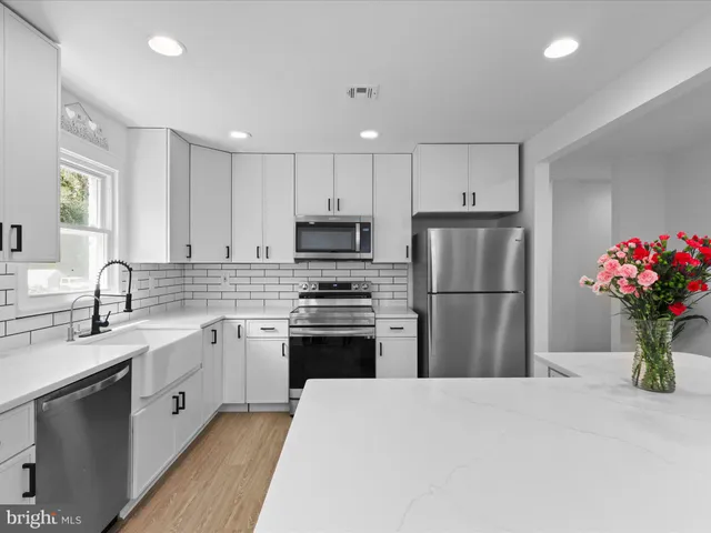 a kitchen with a sink stove and refrigerator