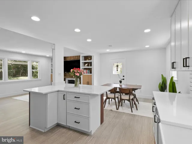 a view of a dining room with furniture and a potted plant