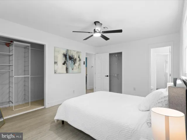 a bedroom with a bed and a painting on the wall