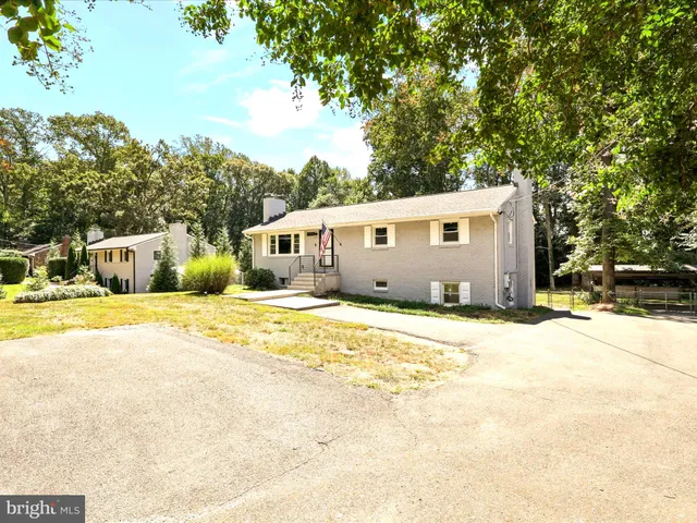 a view of house with yard and swimming pool