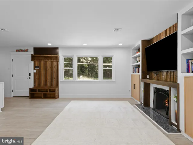 an empty room with furniture fireplace and windows