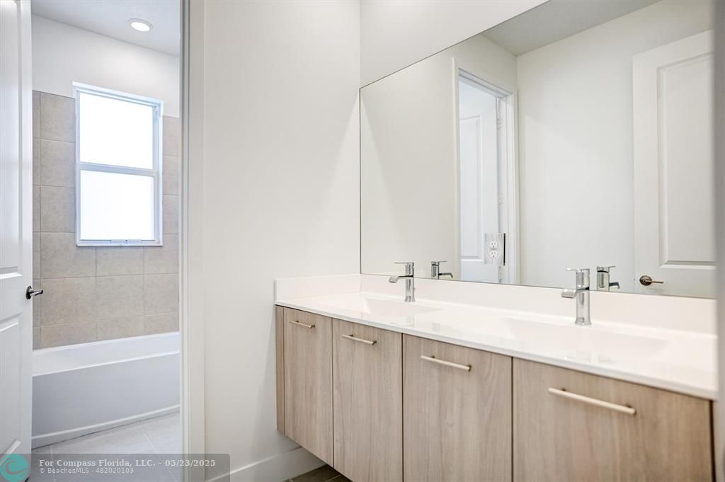 12328 Southwest 43rd Street Davie, FL 33330 - Photo 32 of 96 a bathroom with a double vanity sink and a mirror