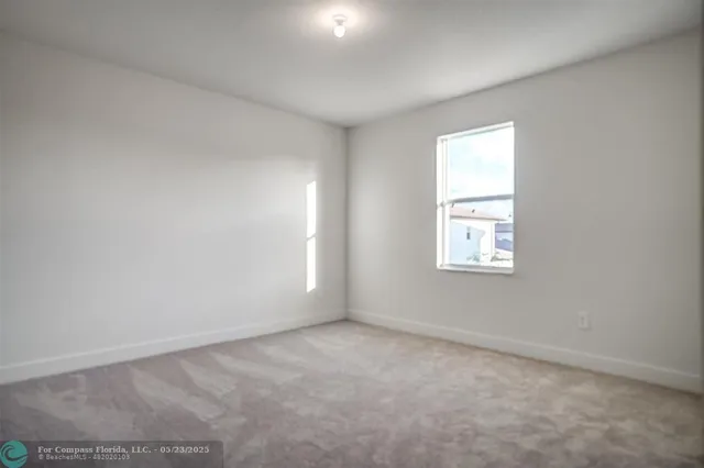 an aerial view of residential houses with yard