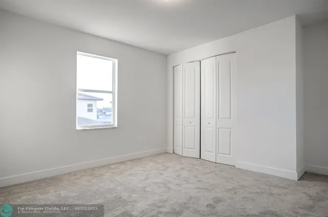 an aerial view of multiple houses with a yard